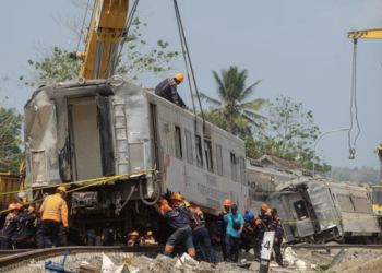 Petugas berusaha mengevakuasi KA Argo Semeru yang mengalami kecelakaan di kawasan Kalimenur, Sukoreno, Sentolo, Kulonprogo.