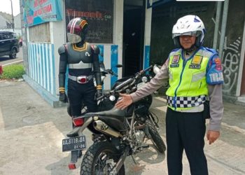 Polisi sedang menilang kesatria baja hitam di perempatan kentungan sleman jogja