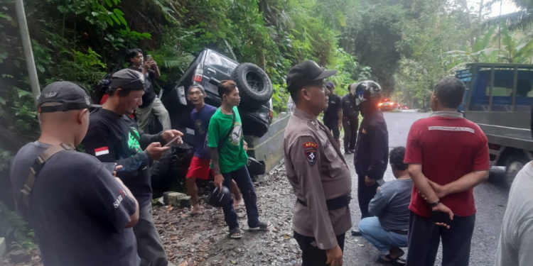 Petugas kepolisian bersama warga mengevakuasi kendaraan Daihatsu F70 yang menabrak tebing akibat rem blong di turunan tajam Jalan Goa Kiskendo, Girimulyo, Kulonprogo