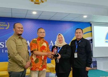 Perwakilan Universitas Alma Ata menyerahkan cinderamata kepada perwakilan SMK Media Informatika Jakarta Selatan usai kegiatan Studi Ekskursi di Auditorium KH. Hasyim Asy’ari, Lantai 9 Universitas Alma Ata, Kamis (29/1/2026).