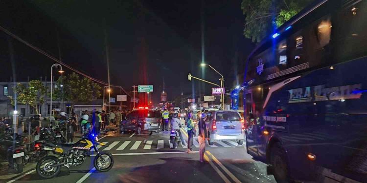 Petugas kepolisian melakukan pengaturan arus lalu lintas dan olah tempat kejadian perkara usai kecelakaan dua minibus di Jalan Yogyakarta–Wates, depan Pasar Baru Sentolo, Kulon Progo, Minggu (11/1/2026) malam. Insiden tersebut menyebabkan sejumlah korban luka dan sempat menimbulkan kepadatan kendaraan di sekitar lokasi.