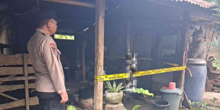 Petugas kepolisian memasang garis polisi di lokasi penemuan seorang lansia yang meninggal dunia di Dusun Salam, Bangunjiwo, Kasihan, Bantul, Rabu (18/2/2026) pagi.