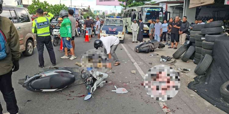 Petugas kepolisian bersama warga berada di lokasi kecelakaan lalu lintas yang melibatkan sepeda motor Honda Beat dan Honda Scoopy di Jalan Wonosari, tepatnya di depan Jakarta Ban, Banguntapan