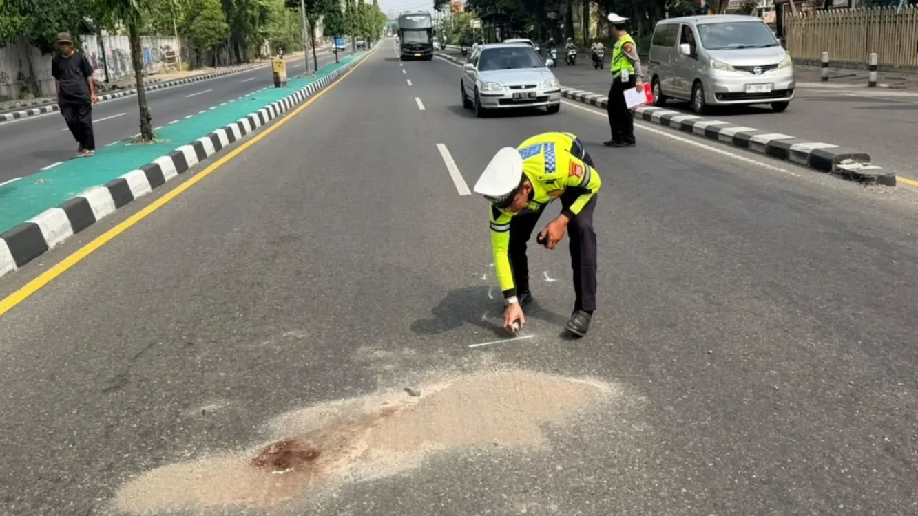 Petugas kepolisian melakukan olah tempat kejadian perkara (TKP) dan memberikan tanda pada titik kecelakaan di Jalan Padjajaran, depan pintu masuk Monjali sebelah barat, Nandan, Sariharjo, Ngaglik, Sleman, Sabtu (22/8/2026). Kecelakaan tersebut melibatkan sepeda motor Yamaha Aerox, Toyota Innova, dan truk Mitsubishi Colt serta mengakibatkan seorang pemotor berusia 19 tahun meninggal dunia.